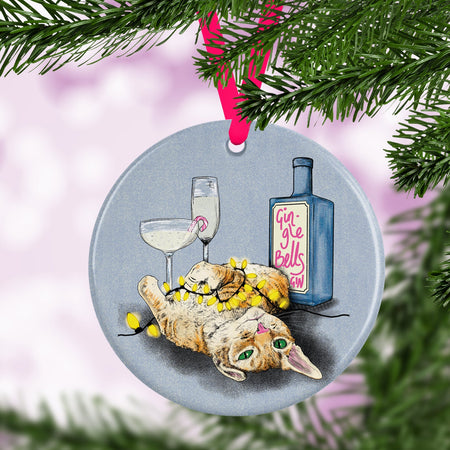 Ceramic Christmas tree ornament with an illustration of a ginger cat tangled in festive lights and bottles of gin and fizz.